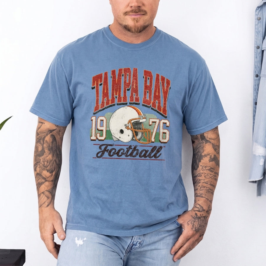 May include a City Football Comfort Colors T-Shirt featuring a football-inspired city graphic, relaxed unisex fit, and casual game-day style.