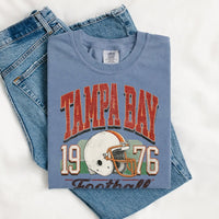 May include a City Football Comfort Colors T-Shirt featuring a football-inspired city graphic, relaxed unisex fit, and casual game-day style.