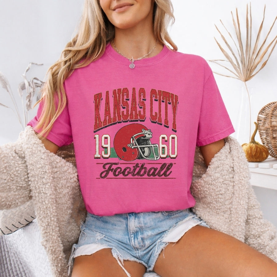 May include a City Football Comfort Colors T-Shirt featuring a football-inspired city graphic, relaxed unisex fit, and casual game-day style.
