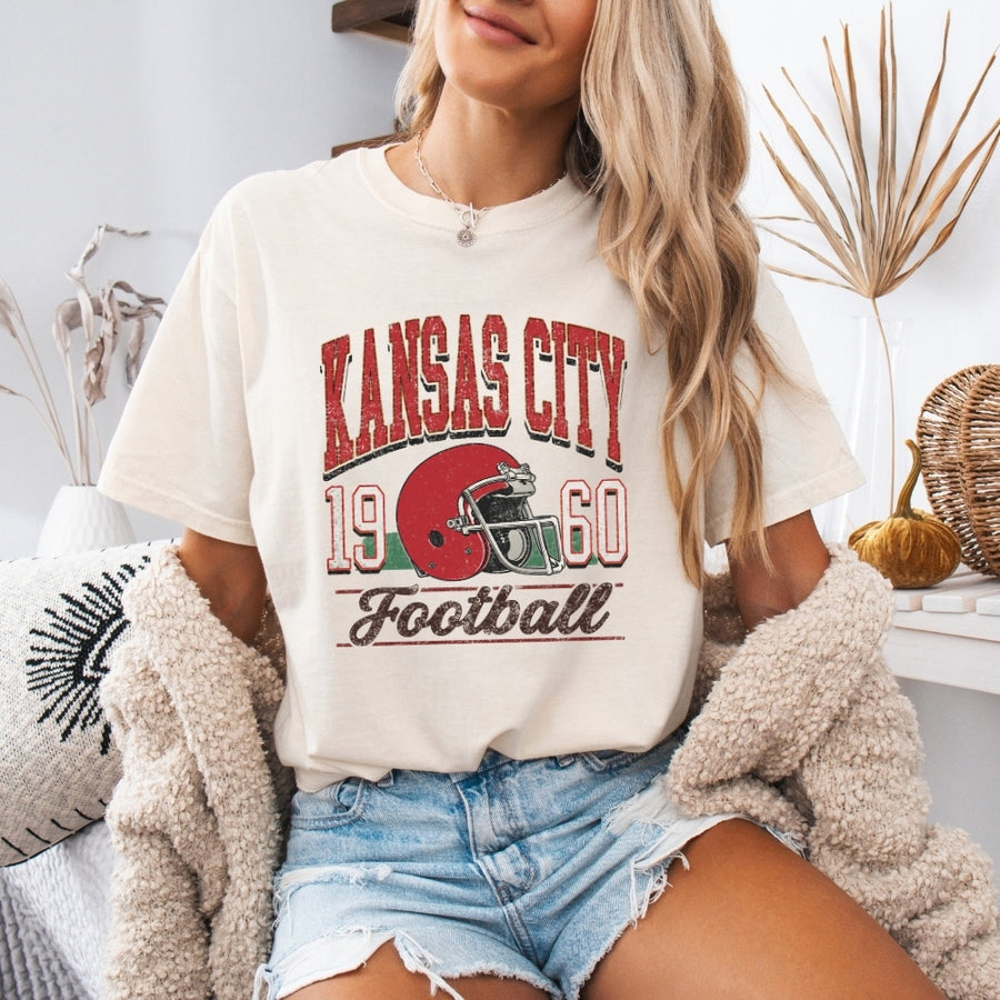 May include a City Football Comfort Colors T-Shirt featuring a football-inspired city graphic, relaxed unisex fit, and casual game-day style.