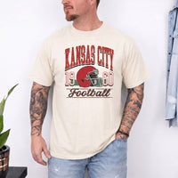 May include a City Football Comfort Colors T-Shirt featuring a football-inspired city graphic, relaxed unisex fit, and casual game-day style.