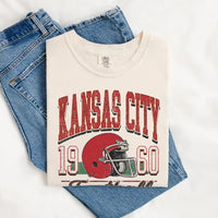 May include a City Football Comfort Colors T-Shirt featuring a football-inspired city graphic, relaxed unisex fit, and casual game-day style.