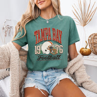 May include a City Football Comfort Colors T-Shirt featuring a football-inspired city graphic, relaxed unisex fit, and casual game-day style.