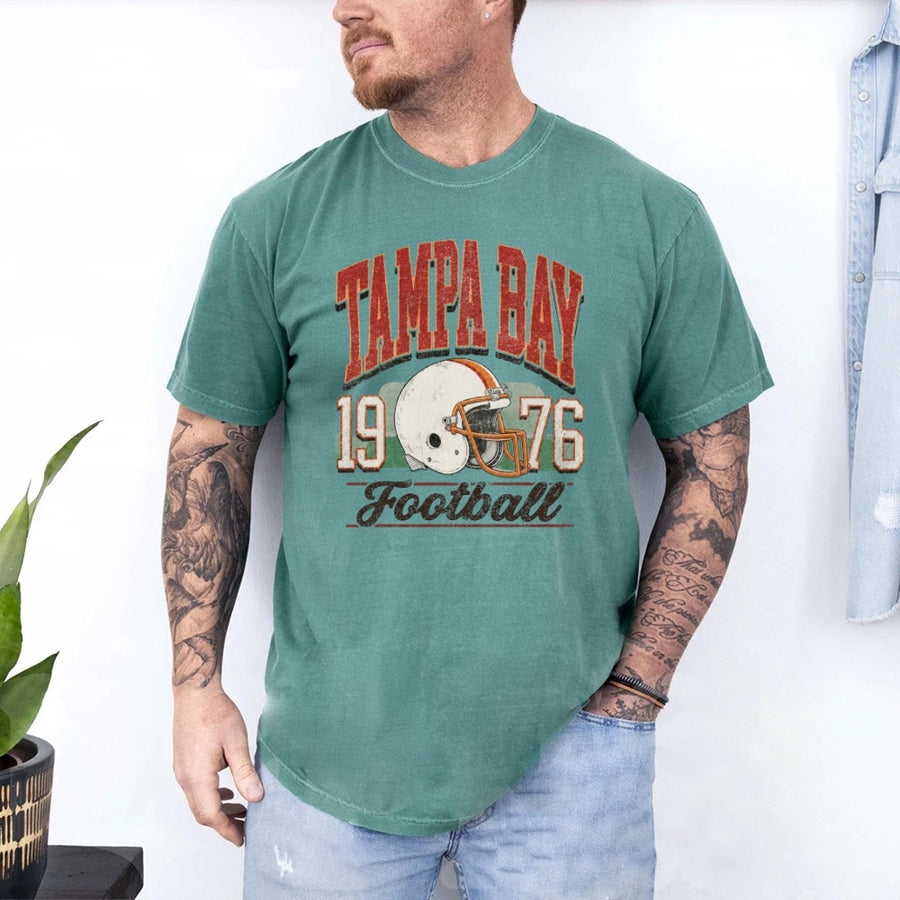 May include a City Football Comfort Colors T-Shirt featuring a football-inspired city graphic, relaxed unisex fit, and casual game-day style.