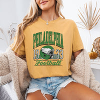May include a City Football Comfort Colors T-Shirt featuring a football-inspired city graphic, relaxed unisex fit, and casual game-day style.