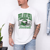 May include a City Football Comfort Colors T-Shirt featuring a football-inspired city graphic, relaxed unisex fit, and casual game-day style.