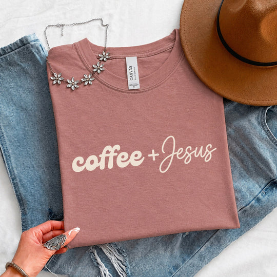 May include a Coffee + Jesus T-Shirt featuring a simple Christian faith and coffee-inspired statement design on a casual short-sleeve tee.