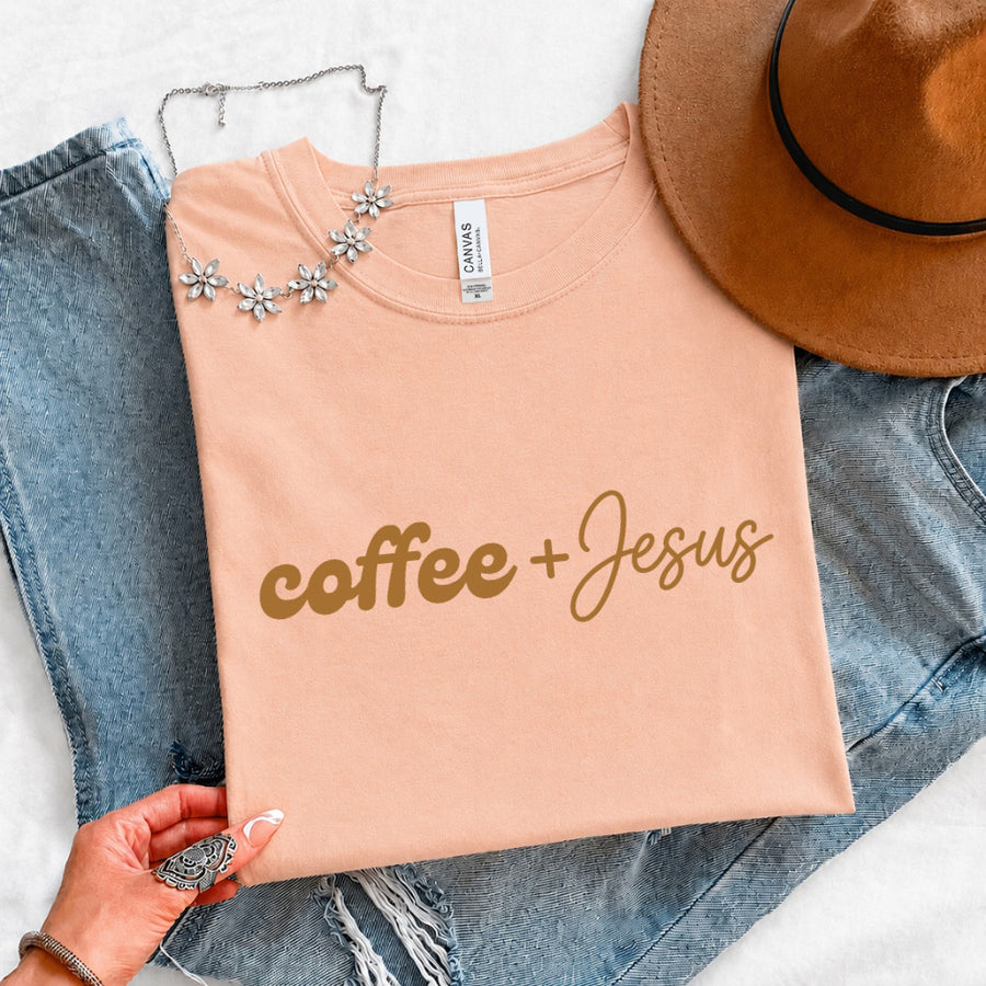 May include a Coffee + Jesus T-Shirt featuring a simple Christian faith and coffee-inspired statement design on a casual short-sleeve tee.