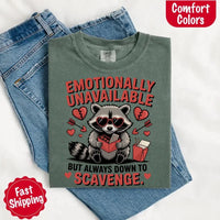 May include a red and black raccoon illustration wearing red sunglasses with the phrase “Emotionally Unavailable,” printed on a Comfort Colors tee for a bold, edgy vibe.