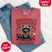 May include a red and black raccoon illustration wearing red sunglasses with the phrase “Emotionally Unavailable,” printed on a Comfort Colors tee for a bold, edgy vibe.