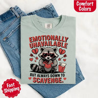 May include a red and black raccoon illustration wearing red sunglasses with the phrase “Emotionally Unavailable,” printed on a Comfort Colors tee for a bold, edgy vibe.