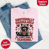 May include a red and black raccoon illustration wearing red sunglasses with the phrase “Emotionally Unavailable,” printed on a Comfort Colors tee for a bold, edgy vibe.