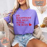 May include bold red distressed typography with the phrase “Go Disappoint The Next Bitch… I’m Busy.” alongside a red heart, expressing sass, confidence, and attitude.