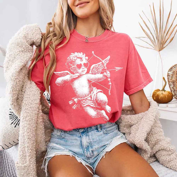 May include a Comfort Colors unisex T-shirt with a halftone pixel art Cupid Valentine’s Day graphic.