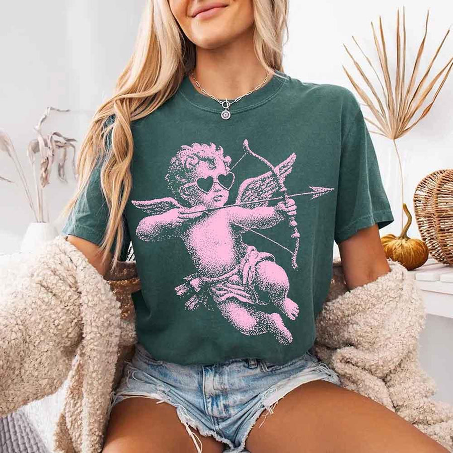 May include a Comfort Colors unisex T-shirt with a halftone pixel art Cupid Valentine’s Day graphic.