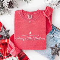 May include a Comfort Colors long sleeve shirt featuring the phrase “Have Yourself a Merry Christmas” in festive print, displayed flat with soft cotton texture and seasonal tones.