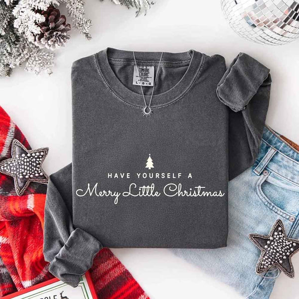 May include a Comfort Colors long sleeve shirt featuring the phrase “Have Yourself a Merry Christmas” in festive print, displayed flat with soft cotton texture and seasonal tones.