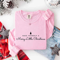 May include a Comfort Colors long sleeve shirt featuring the phrase “Have Yourself a Merry Christmas” in festive print, displayed flat with soft cotton texture and seasonal tones.