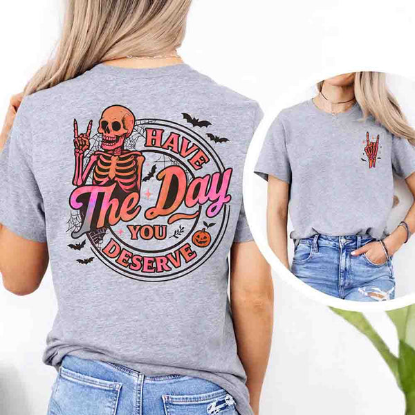 May include skeleton Halloween graphic with holographic lettering ‘Have the Day You Deserve,’ skeleton hand gesture, bats, spider webs, and pumpkin accent – spooky graphic tee design.