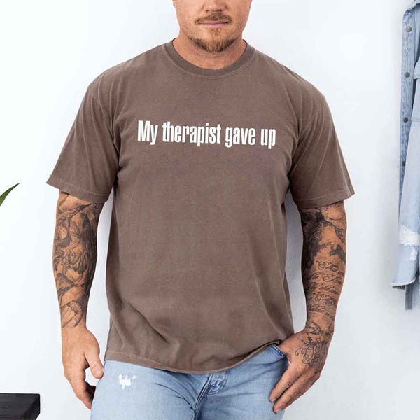 May include a Comfort Colors short-sleeve shirt with the printed phrase My Therapist Gave Up in a simple, bold design.