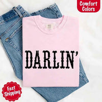 May include bold black distressed Western-style typography featuring the word “Darlin’,” evoking country charm with a vintage, rustic feel.