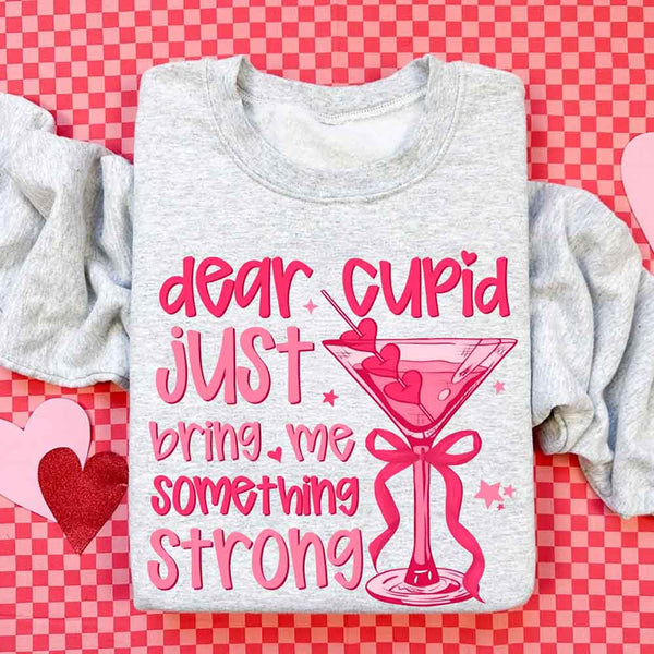 May include a unisex T-shirt with the phrase Dear Cupid Something Strong printed clearly on the front.