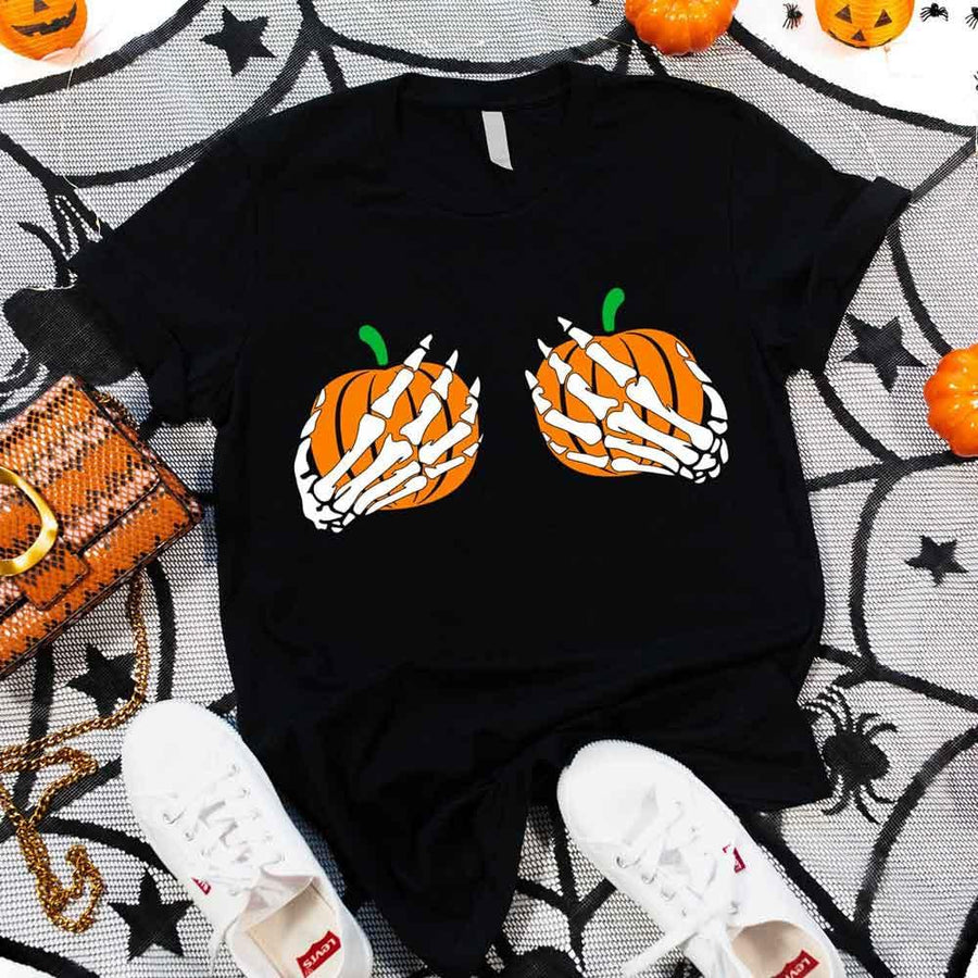 May include Halloween graphic with two pumpkins being grabbed by white skeleton hands on black background – spooky funny design.