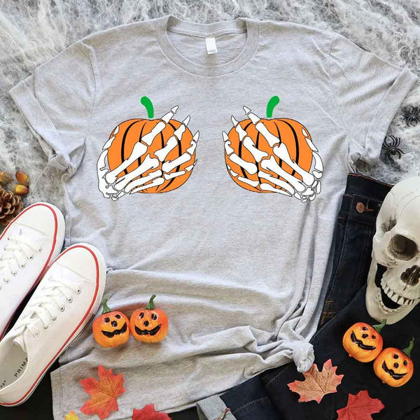 May include Halloween graphic with two pumpkins being grabbed by white skeleton hands on black background – spooky funny design.