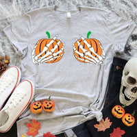 May include Halloween graphic with two pumpkins being grabbed by white skeleton hands on black background – spooky funny design.