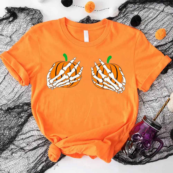 May include Halloween graphic with two pumpkins being grabbed by white skeleton hands on black background – spooky funny design.