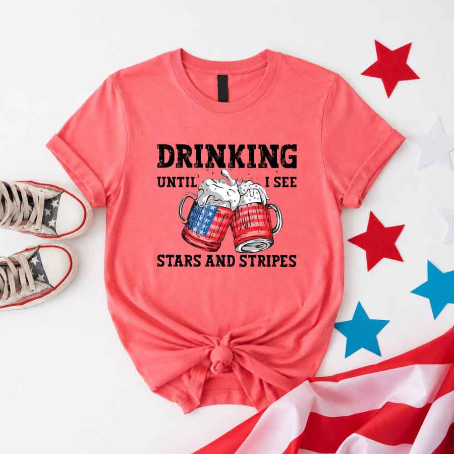 May include Drinking Until I See The Stars And Stripes 4th of July graphic tee with patriotic design and relaxed fit