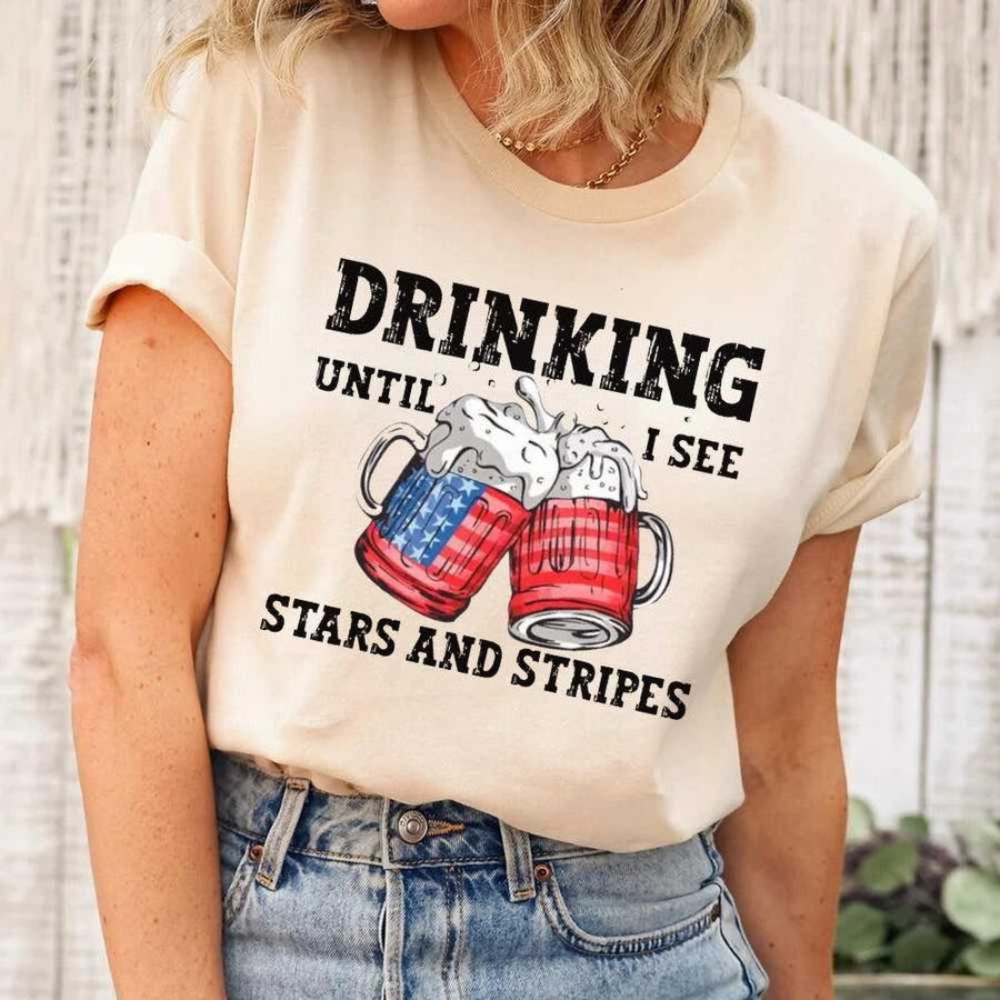 May include Drinking Until I See The Stars And Stripes 4th of July graphic tee with patriotic design and relaxed fit
