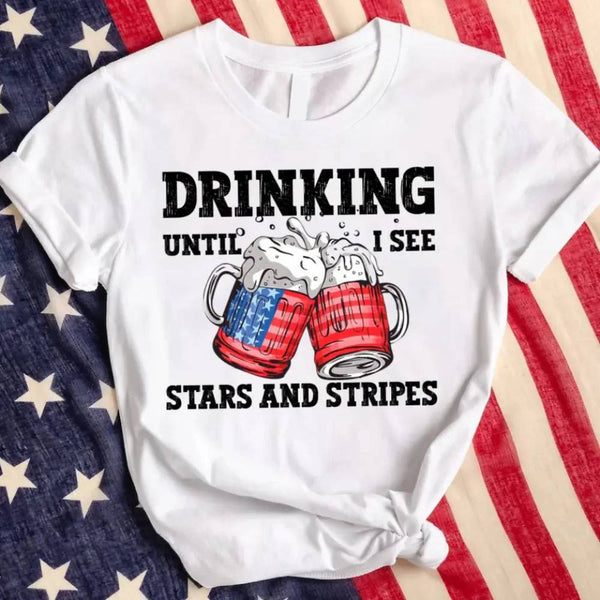 May include Drinking Until I See The Stars And Stripes 4th of July graphic tee with patriotic design and relaxed fit