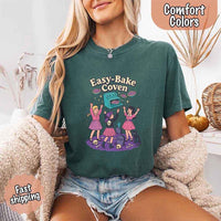 May include Easy Bake Coven graphic with three witch girls baking pies, retro oven, skulls, gravestone, and black cat – vintage 90s Halloween shirt.