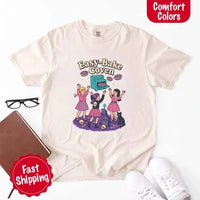 May include Easy Bake Coven graphic with three witch girls baking pies, retro oven, skulls, gravestone, and black cat – vintage 90s Halloween shirt.