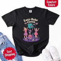 May include Easy Bake Coven graphic with three witch girls baking pies, retro oven, skulls, gravestone, and black cat – vintage 90s Halloween shirt.