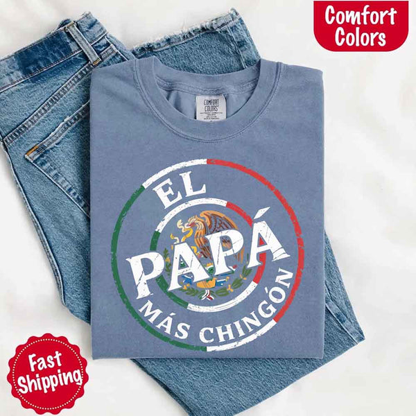 May include bold distressed text that reads “El Papá Más Chingón” over a circular Mexican flag-inspired design with an eagle emblem, celebrating proud and confident fatherhood with cultural pride.