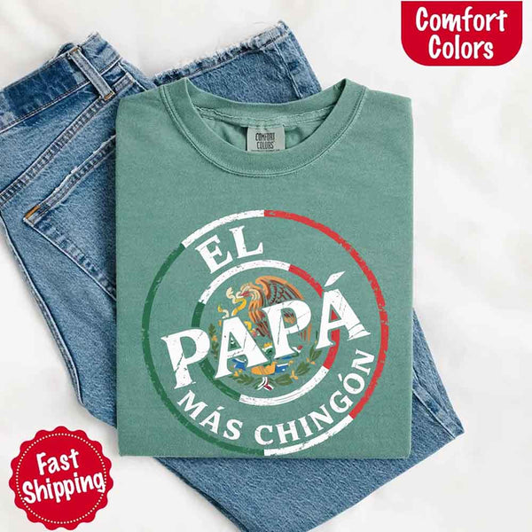 May include bold distressed text that reads “El Papá Más Chingón” over a circular Mexican flag-inspired design with an eagle emblem, celebrating proud and confident fatherhood with cultural pride.