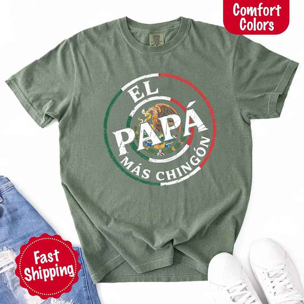 May include bold distressed text that reads “El Papá Más Chingón” over a circular Mexican flag-inspired design with an eagle emblem, celebrating proud and confident fatherhood with cultural pride.