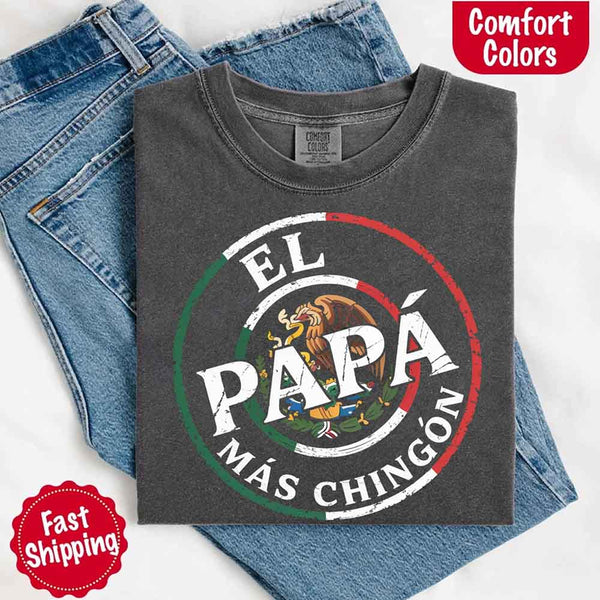 May include bold distressed text that reads “El Papá Más Chingón” over a circular Mexican flag-inspired design with an eagle emblem, celebrating proud and confident fatherhood with cultural pride.