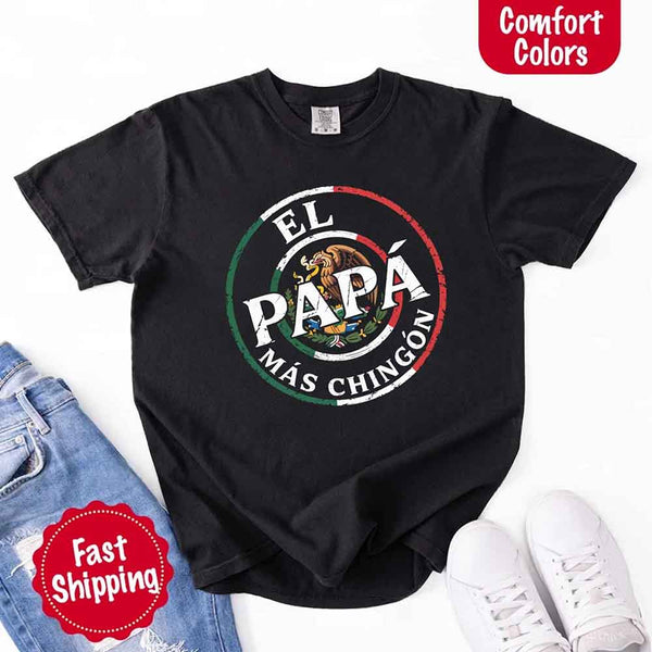 May include bold distressed text that reads “El Papá Más Chingón” over a circular Mexican flag-inspired design with an eagle emblem, celebrating proud and confident fatherhood with cultural pride.