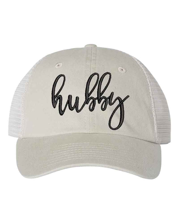 May include an embroidered pigment-dyed trucker hat with mesh back, featuring “Wifey” or “Hubby” text, designed as a casual and stylish gift for spouses or anniversaries.
