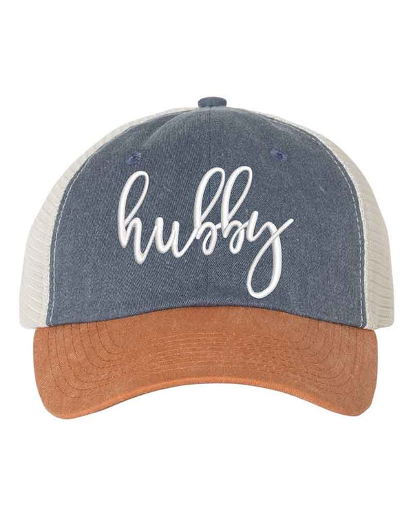 May include an embroidered pigment-dyed trucker hat with mesh back, featuring “Wifey” or “Hubby” text, designed as a casual and stylish gift for spouses or anniversaries.