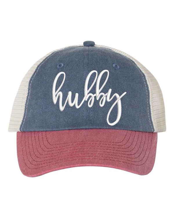 May include an embroidered pigment-dyed trucker hat with mesh back, featuring “Wifey” or “Hubby” text, designed as a casual and stylish gift for spouses or anniversaries.