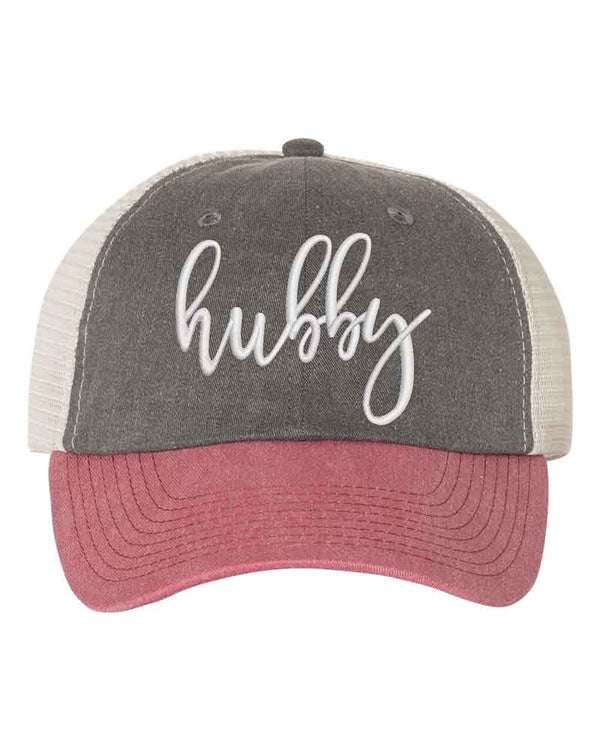 May include an embroidered pigment-dyed trucker hat with mesh back, featuring “Wifey” or “Hubby” text, designed as a casual and stylish gift for spouses or anniversaries.