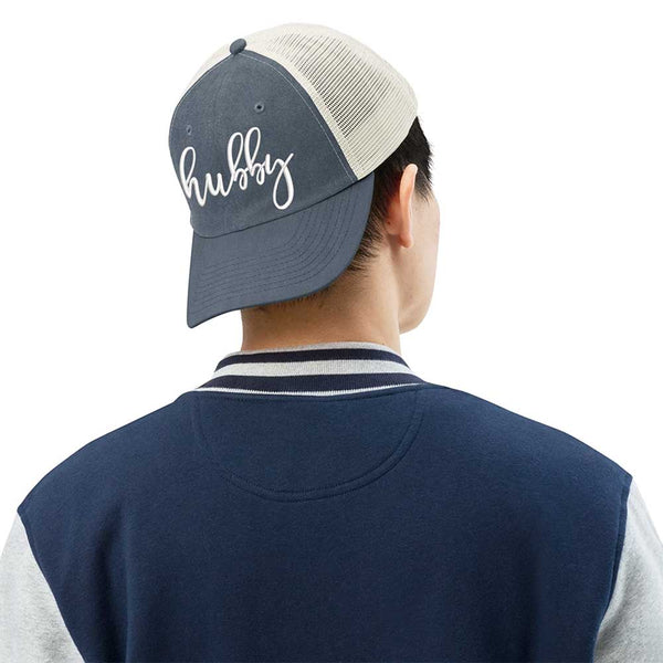 May include an embroidered pigment-dyed trucker hat with mesh back, featuring “Wifey” or “Hubby” text, designed as a casual and stylish gift for spouses or anniversaries.
