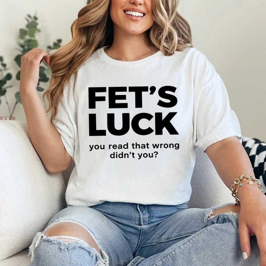 May include a graphic t-shirt featuring the phrase “FET’S LUCK” designed as an optical illusion.