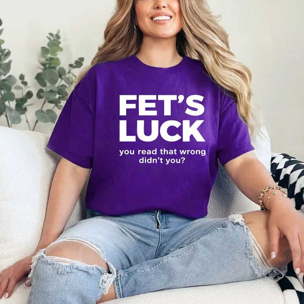 May include a graphic t-shirt featuring the phrase “FET’S LUCK” designed as an optical illusion.