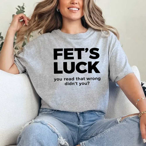 May include a graphic t-shirt featuring the phrase “FET’S LUCK” designed as an optical illusion.