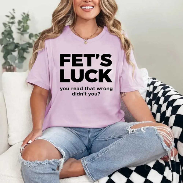 May include a graphic t-shirt featuring the phrase “FET’S LUCK” designed as an optical illusion.
